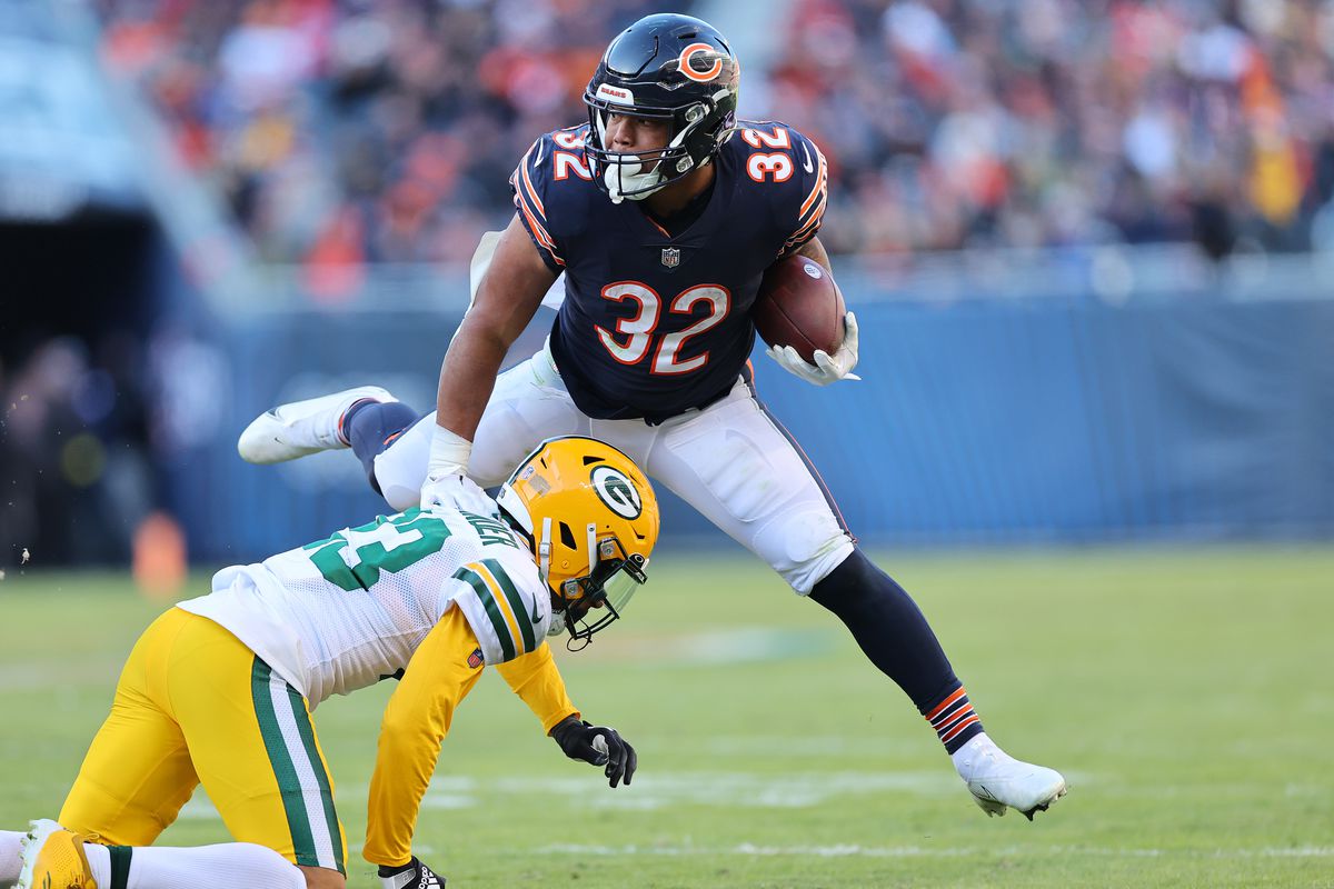 David Montgomery #32 of the Chicago Bears breaks a tackle by Jaire Alexander #23 of the Green Bay Packers during the third quarter at Soldier Field on December 04, 2022 in Chicago, Illinois.