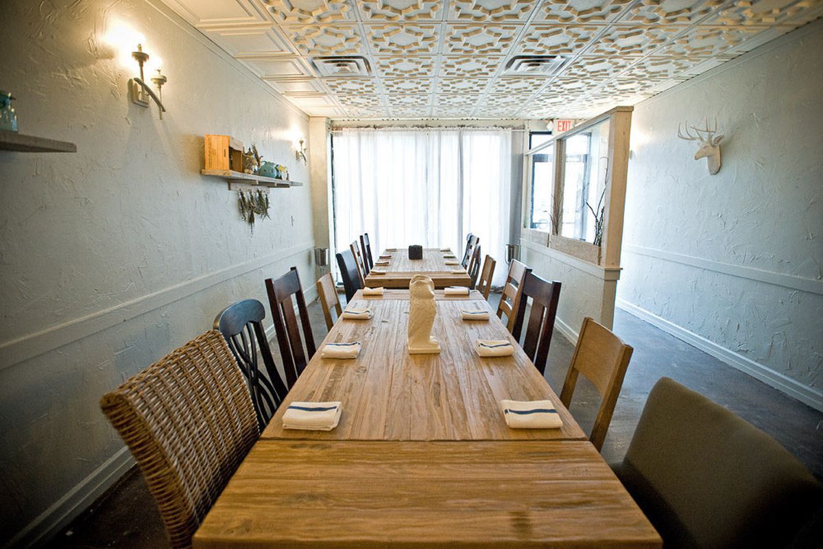 The intimate restaurant features three long communal tables