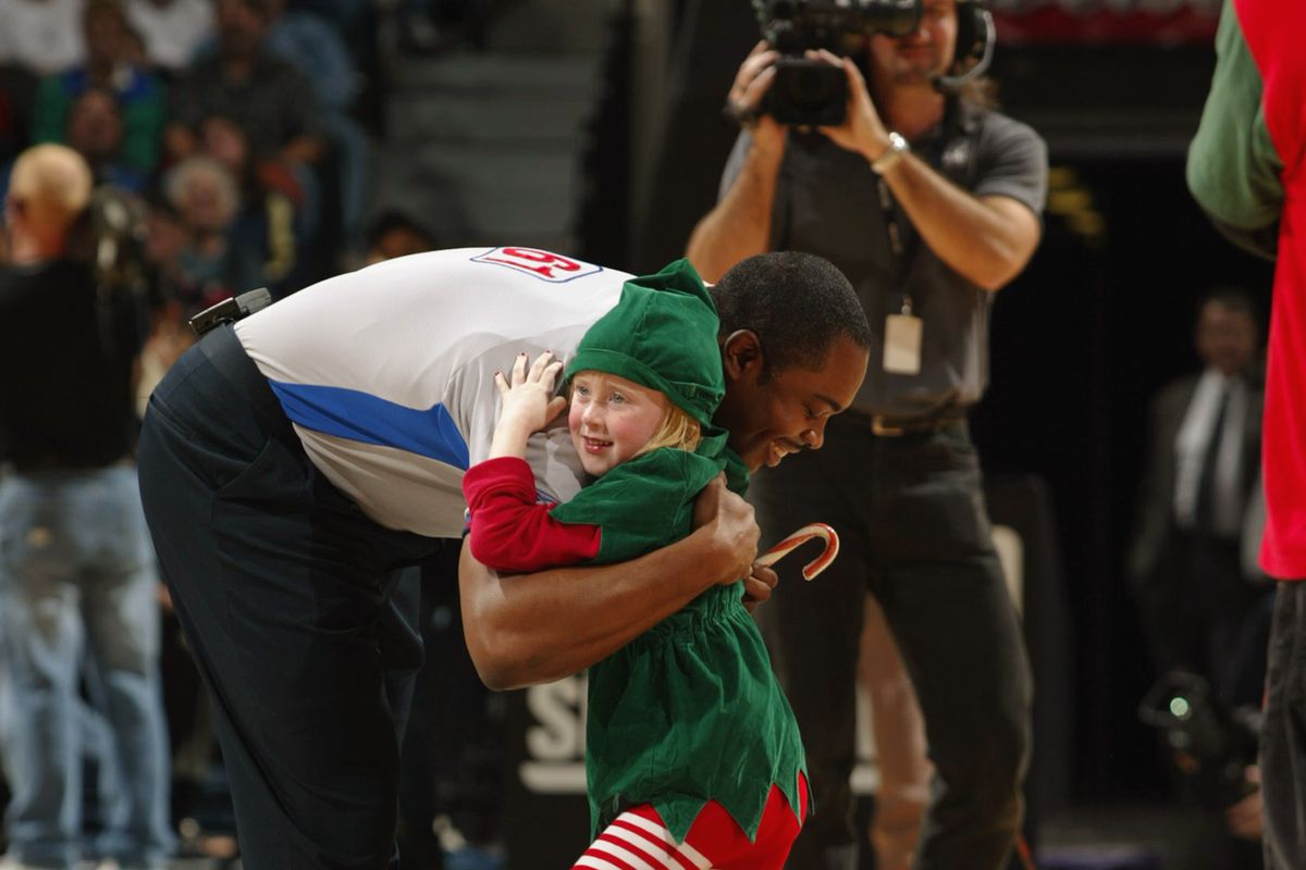 A little elf hugs the referee