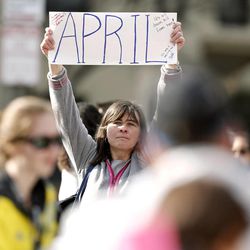 Justine Franco of Montpelier, Vt., holds up a sign near Copley Square in Boston looking for her missing friend, April, who was running in her first Boston Marathon Monday, April 15, 2013. Two bombs exploded near the finish line of the marathon on Monday, killing at least two people and injuring at least 23 others.