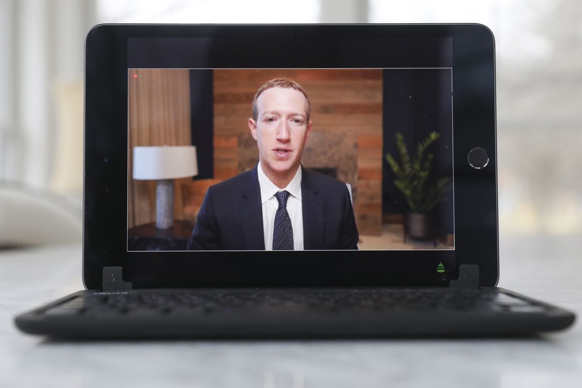 Facebook CEO Mark Zuckerberg on a laptop screen as he speaks to Congress.