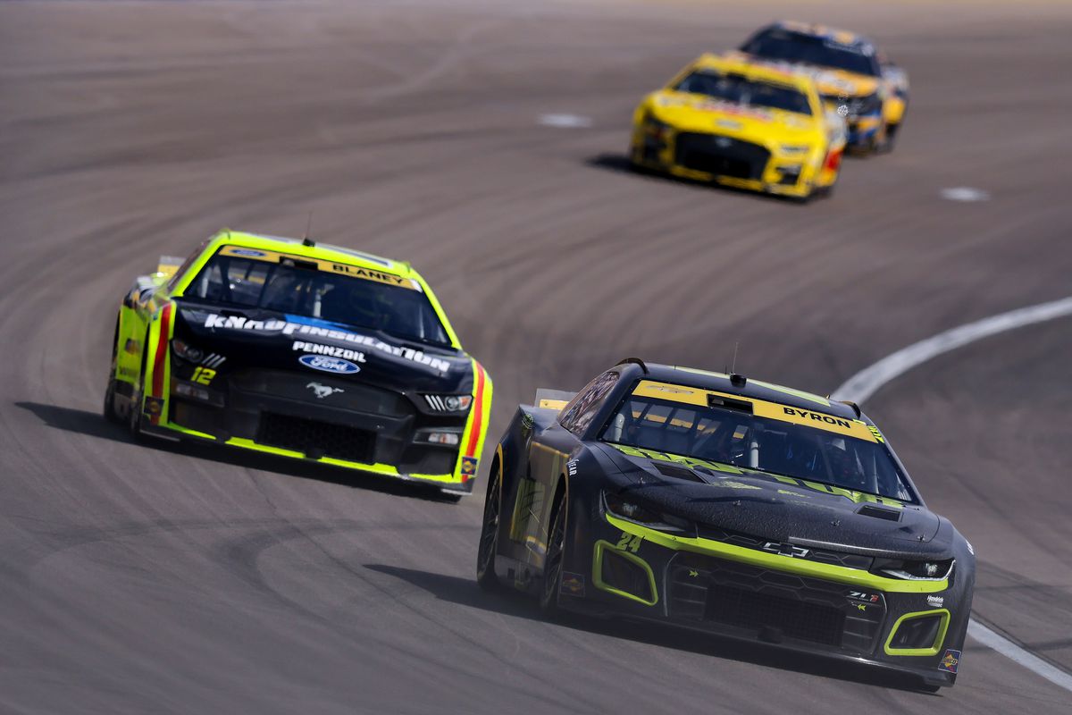 William Byron, driver of the #24 RaptorTough.com Chevrolet, and Ryan Blaney, driver of the #12 Menards\Knauf Ford, race during the NASCAR Cup Series South Point 400 at Las Vegas Motor Speedway on October 16, 2022 in Las Vegas, Nevada.