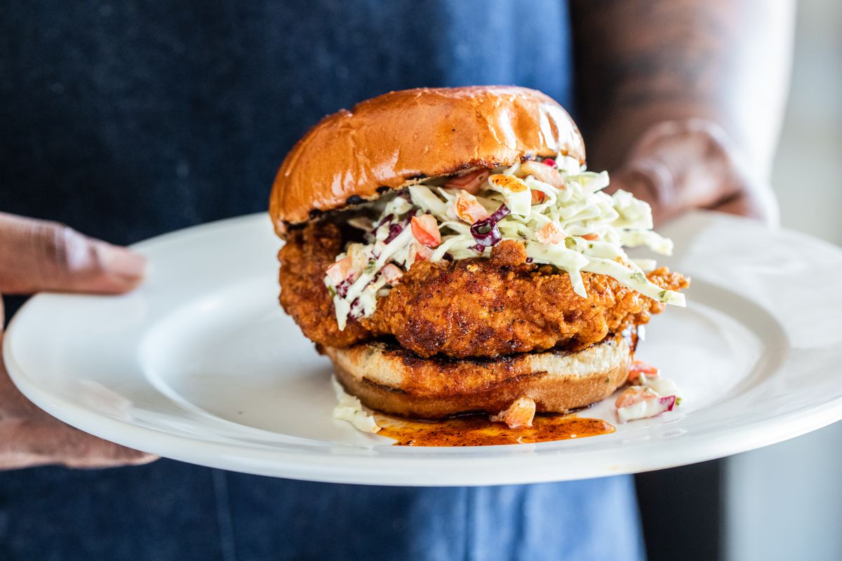 Gatlin’s Fins & Feathers chicken sandwich, topped with a Cajun hot sauce and coleslaw on a bun.