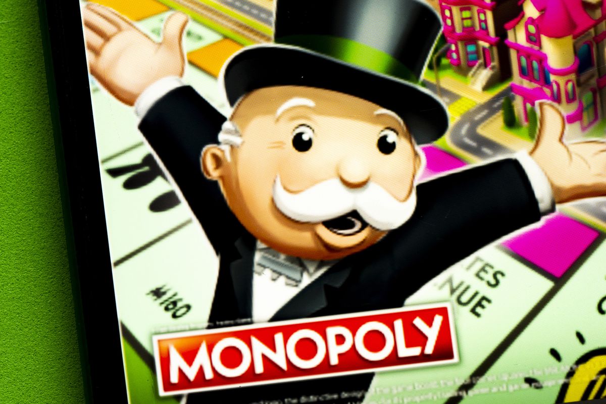 In this photo illustration a Monopoly Board Games, Card &amp;...