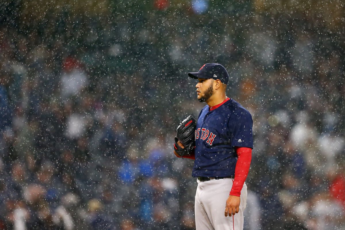 Eduardo Rodriguez #57 of the Boston Red Sox gets set to pitch as the rain falls in the fourth inning against the New York Yankees at Yankee Stadium on May 10, 2018 in the Bronx borough of New York City.