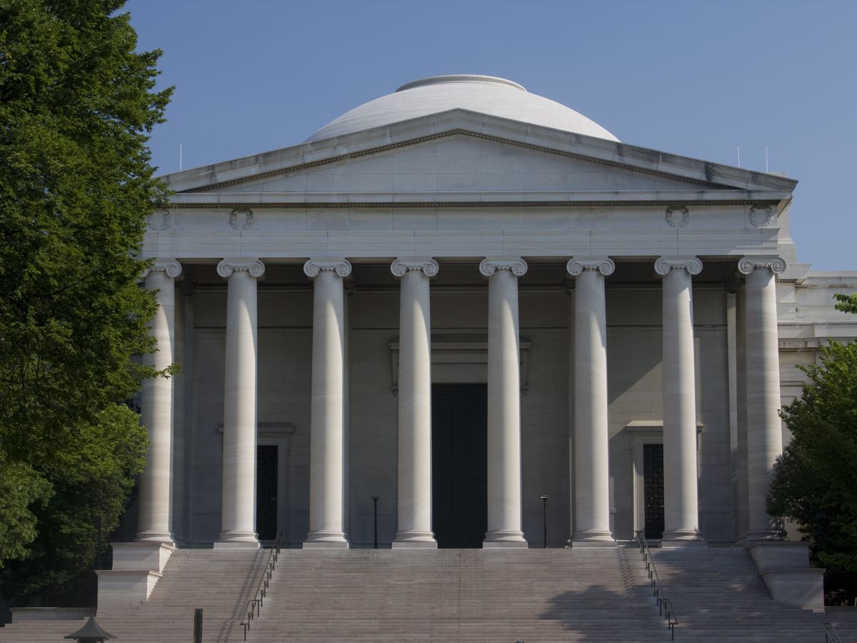 A neoclassical building with eight columns and a dome.