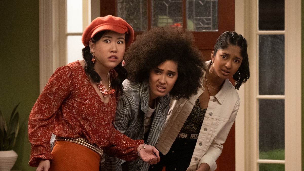 Eleanor, Fabiola, and Devi look skeptically at something ahead in Never Have I Ever season 2.
