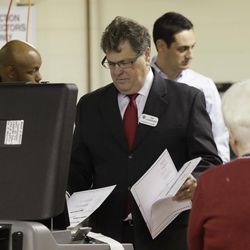 Milwaukee County Clerk Joe Czarnezki feeds test ballots during a statewide presidential election recount Thursday, Dec. 1, 2016, in Milwaukee. The first candidate-driven statewide recount of a presidential election in 16 years began Thursday in Wisconsin, a state that Donald Trump won by less than a percentage point over Hillary Clinton after polls long predicted a Clinton victory. 