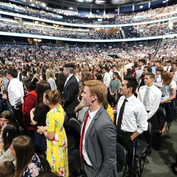 Young men and women stand at the request of President Russell M. Nelson as he speaks at a near-capacity crowd at the Amway Center in Orlando, Florida, on Sunday, June 9, 2019.