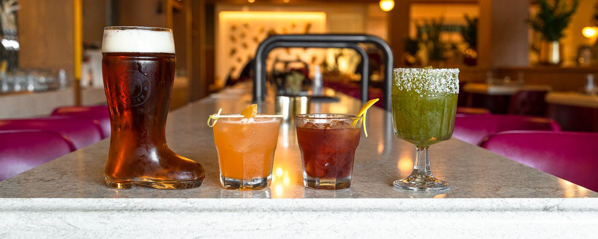 A lineup of drinks on a bar.