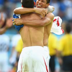 Cristian Gamboa and Oscar Granados of Costa Rica hug in celebration