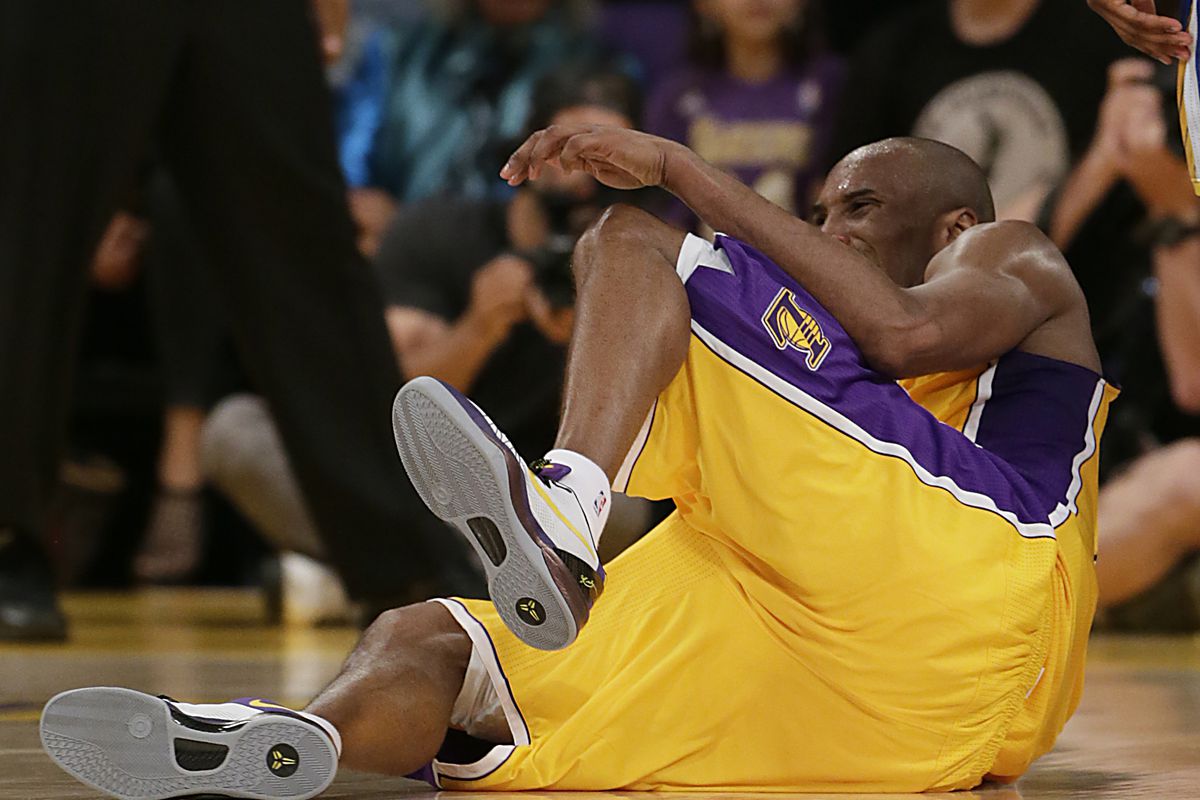Kobe Bryant rolls on the ground in pain as he injures his achilles tendon late in the fourth quarte