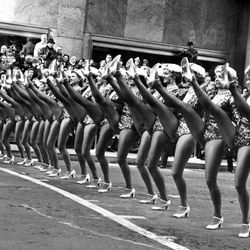 Some of the Radio City Music Hall’s Rockettes as they were performing in the annual Macy’s Thanksgiving Day parade in New York on Nov. 27, 1958. Some of the police-estimated 1,250,000 that watched the parade keep an eye on the dancers as they approach 34th Street and Broadway, near the end of the march.