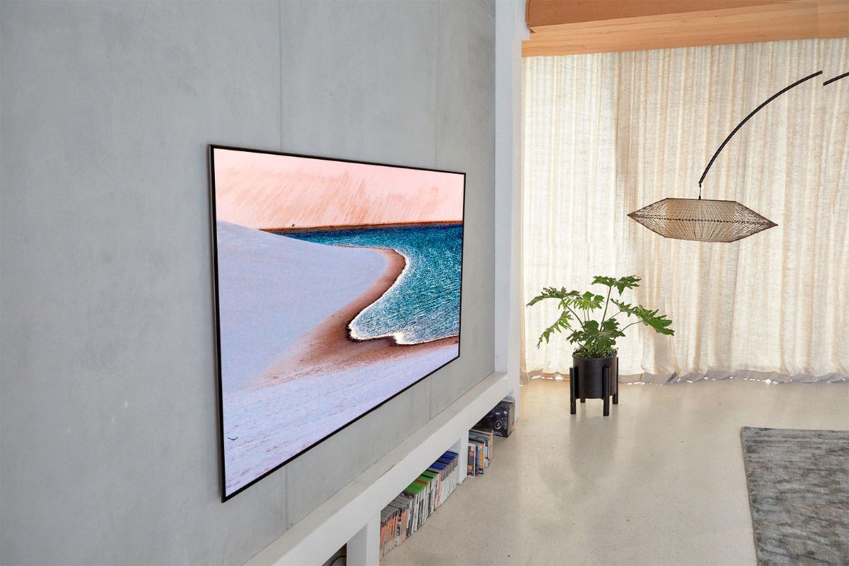 An LG GX OLED TV installed on a living room wall