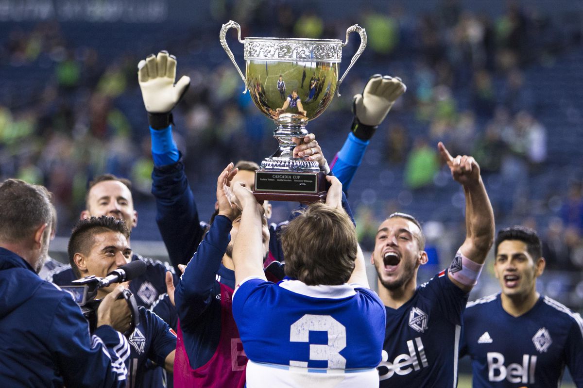 Vancouver Southsiders President, Peter Czimmermann (wearing #3 shirt) presents the Cascadia Cup to the Vancouver Whitecaps