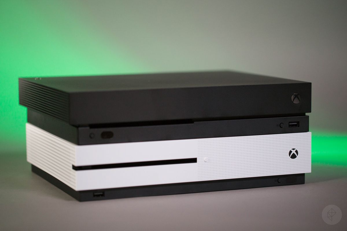 Xbox One X on top of Xbox One S, left front angle view