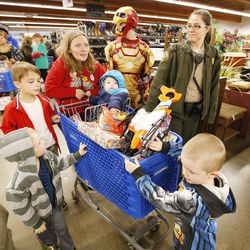 Officer Erin Frank shops with Bonnie Westover and her children at Goodwill in Millcreek on Saturday, Dec. 3, 2016. The Rotary Club of Midvale partnered with the Unified Police Department for 102 needy children to shop.