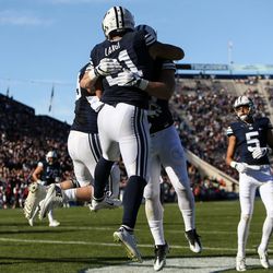 Brigham Young Cougars linebacker Harvey Langi (21) celebrates after running for a touchdown, putting BYU up 27-9 after the PAT, during a game against the UMass Minutemen at LaVell Edwards Stadium in Provo on Saturday, Nov. 19, 2016.