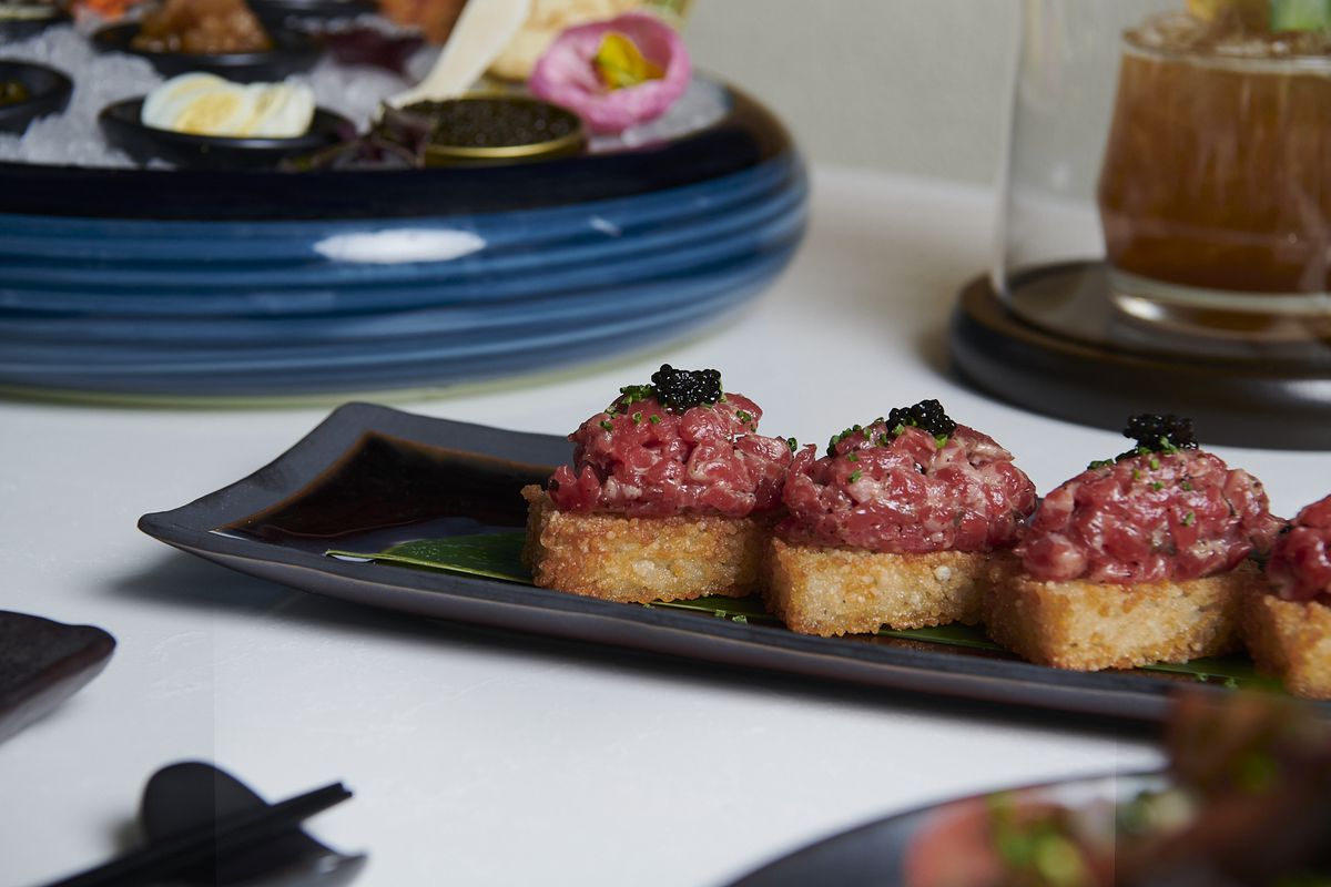 Crisped ovals of rice arrive topped with minced wagyu beef, with caviar, truffle, and chives.