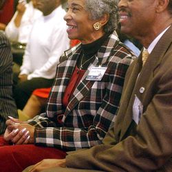 Bishop Willie Dunn and Louise Dunn laugh as they listen to Darius Gray's presentation of his own family research during an African-American open house on family research at the Family History Library in Salt Lake City in February 2003.