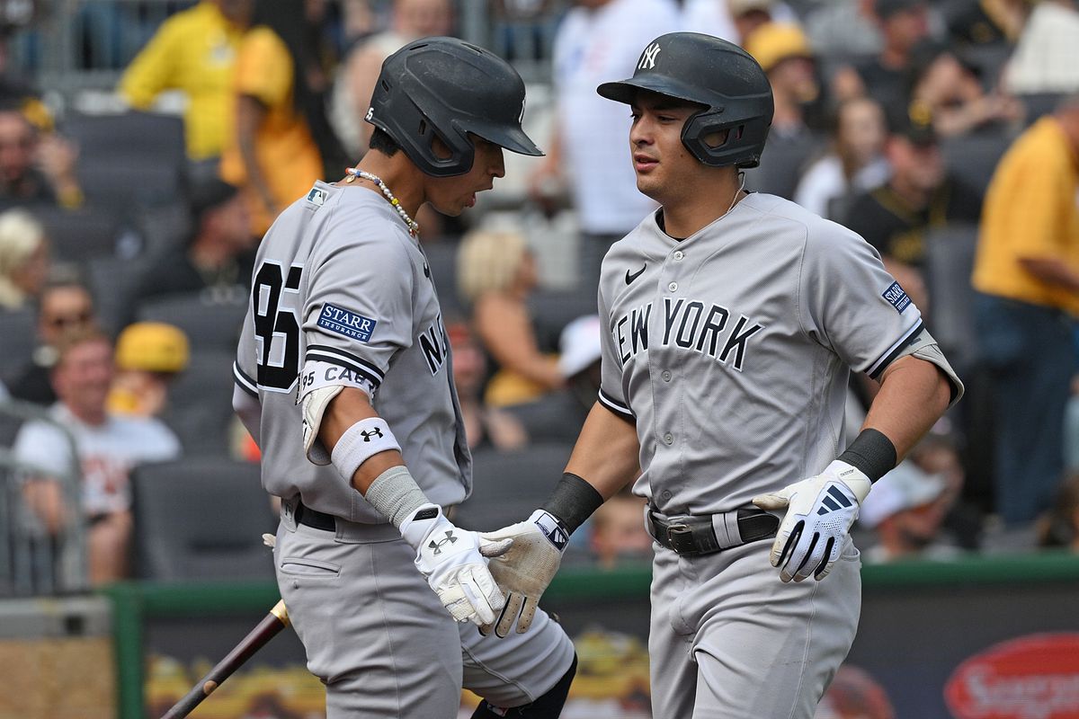 Anthony Volpe of the New York Yankees celebrates with Oswaldo Cabrera after hitting a solo home run in the seventh inning during the game against the Pittsburgh Pirates at PNC Park on September 17, 2023 in Pittsburgh, Pennsylvania.