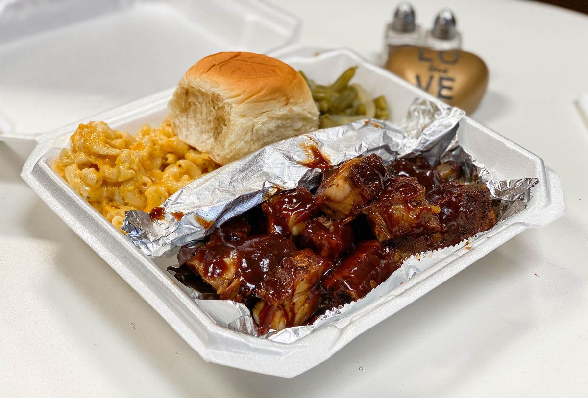 A plate of sauced ribs, mac &amp; cheese, and more from a soul food restaurant in Lancaster, CA.