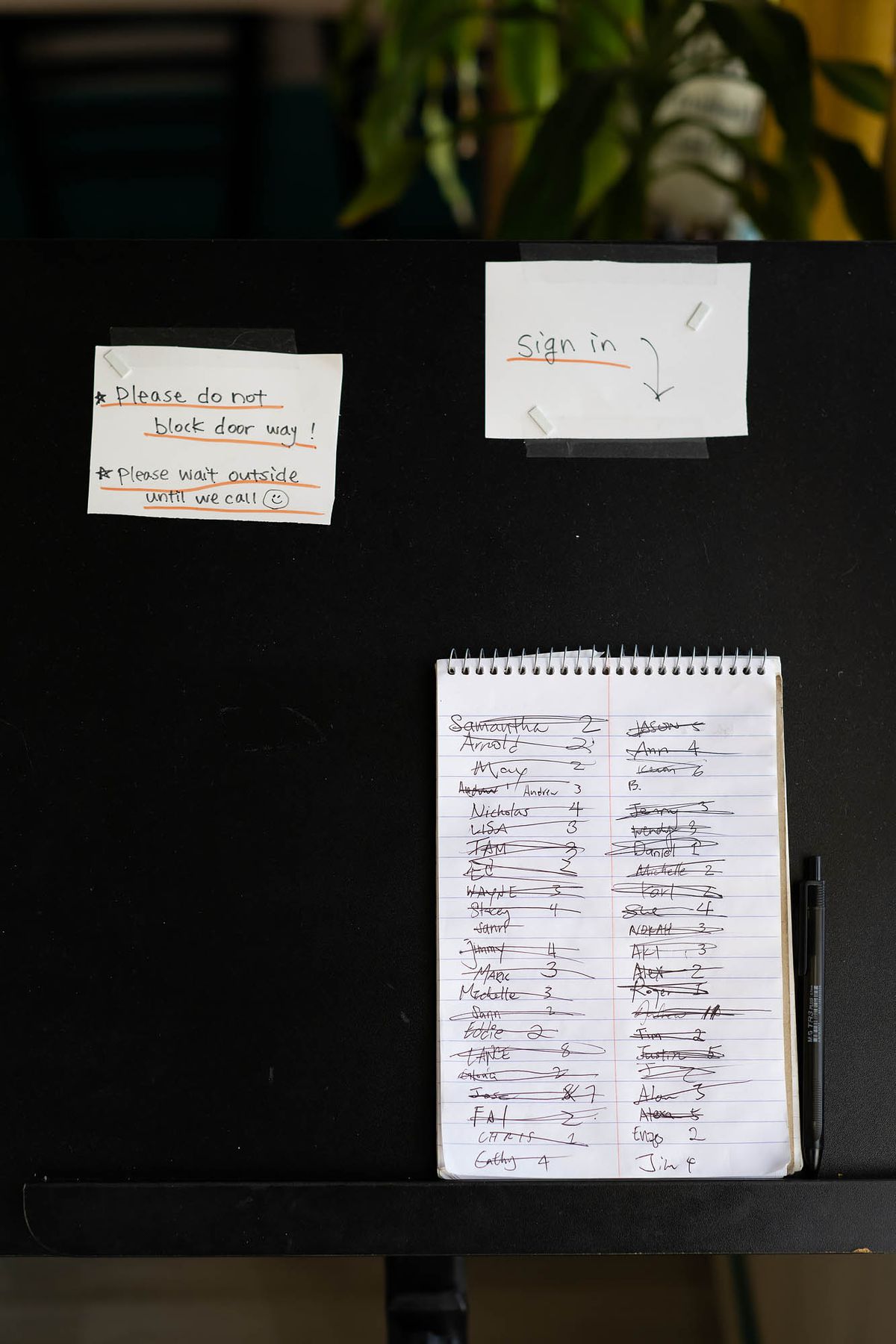 Hand-written waiting list at Ducks San Gabriel.