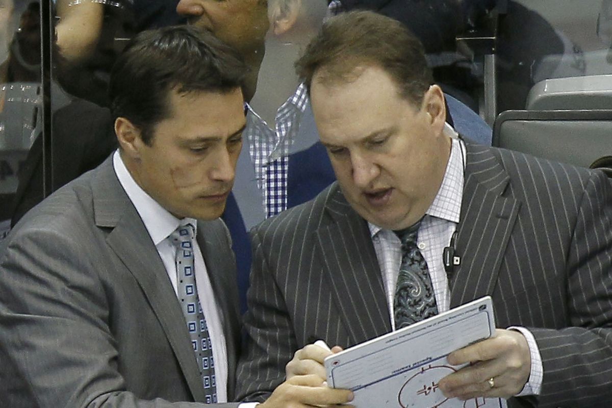 Former head coach Guy Boucher (left) and former assistant Martin Raymond (right) review some documentation. Raymond was named head coach of Drummondville of the QMJHL on Tuesday.
