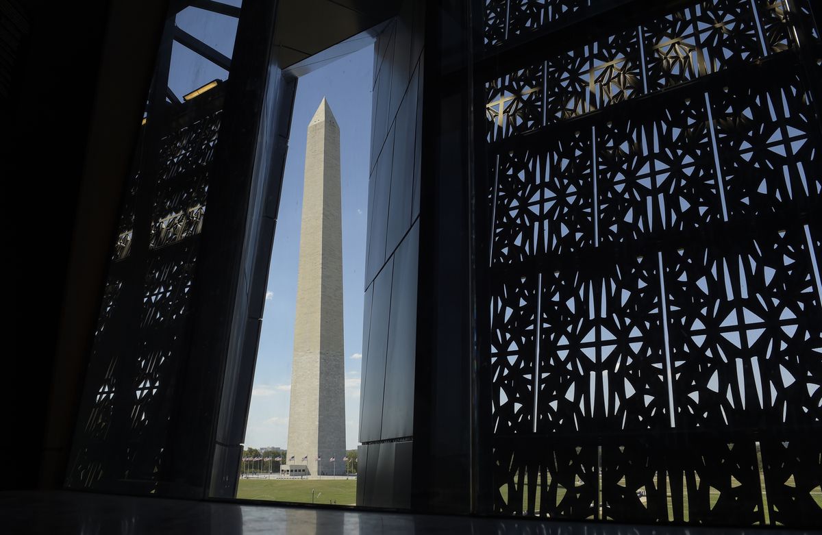 The Washington Monument is framed by a window at the National Museum of African American History and Culture in Washington. | AP