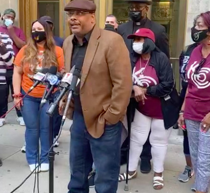 Community organizer Rod Wilson of the Lugenia Burns Hope Center stands outside Chicago City Hall with other community group leaders who are pushing back against a compromise plan that would delay school board elections until 2024.