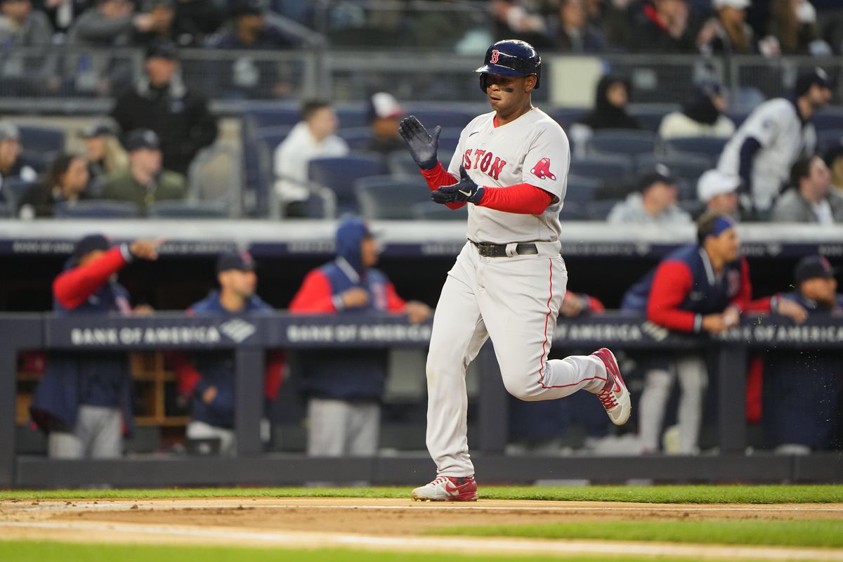 Boston Red Sox third baseman Rafael Devers (11) scores a run on Boston Red Sox designated hitter J.D. Martinez (28) (not pictured) RBI double against the New York Yankees during the first inning at Yankee Stadium.