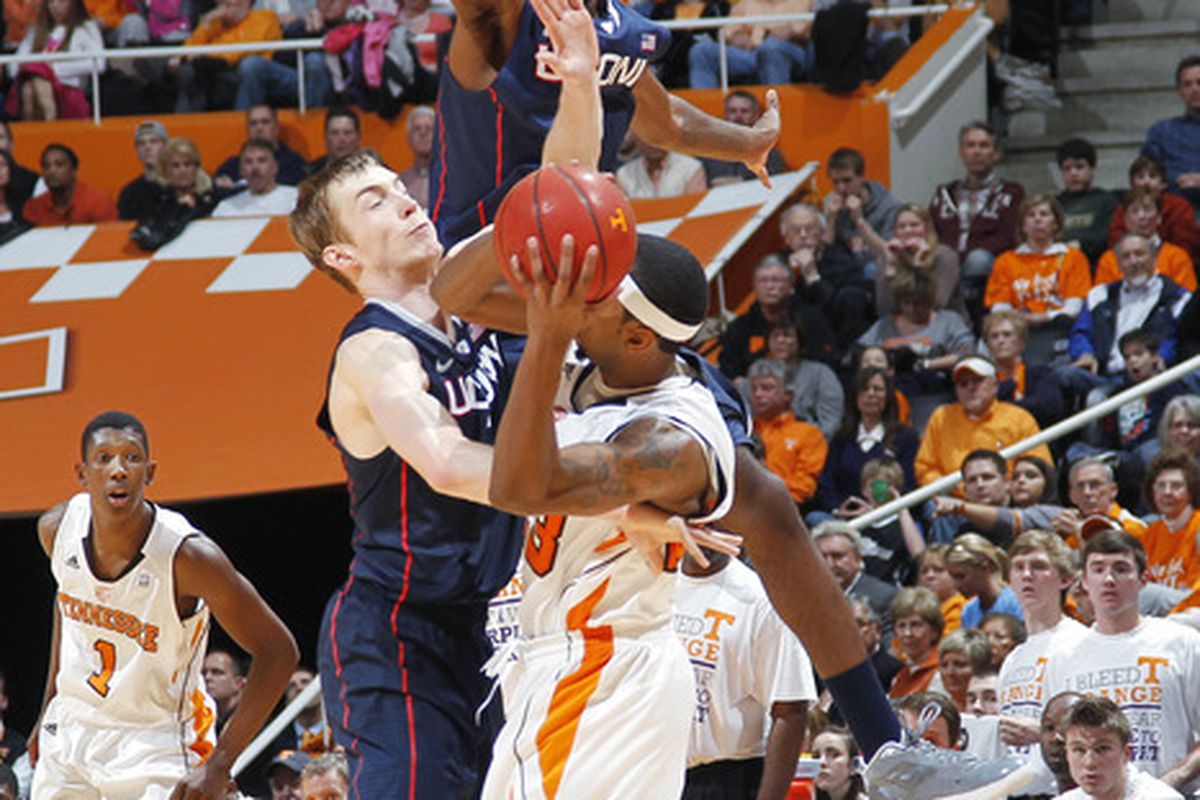 Roscoe Smith and Niels Giffey defend a Tennessee player behind the three point line. This was the closest image I could find to "three point defense". (Photo by Joe Robbins/Getty Images)