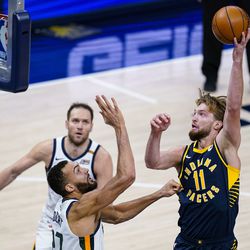 Indiana Pacers forward Domantas Sabonis (11) shoots over Utah Jazz center Rudy Gobert (27) during the second half of an NBA basketball game in Indianapolis, Sunday, Feb. 7, 2021. 