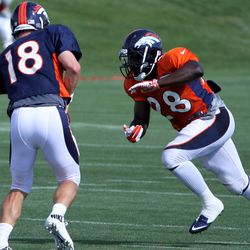 Broncos quarterback Peyton Manning hands off to RB Montee Ball on day 3 of training camp