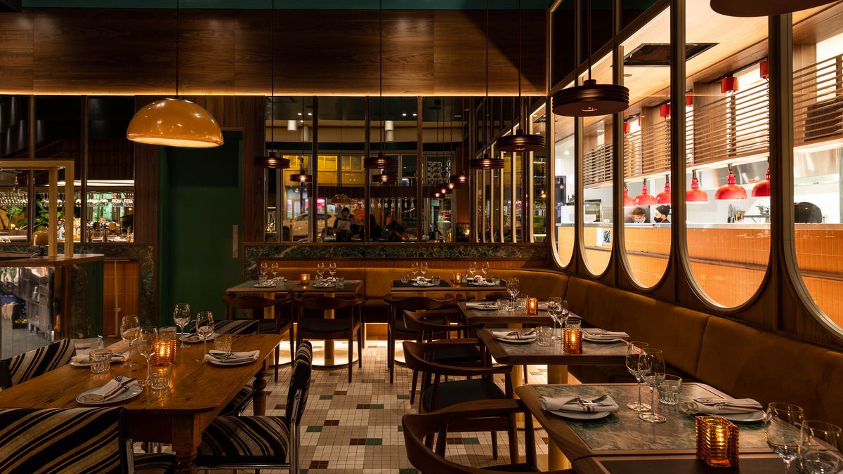 photo of restaurant with with retro lights, rounded furniture, multicoloured tiles