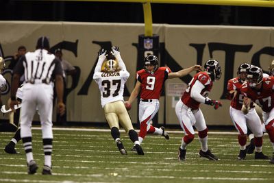 Saints’ Steve Gleason (37) goes high to block the kick of Falcons’ punter Michael Koenen (9) during first half action.