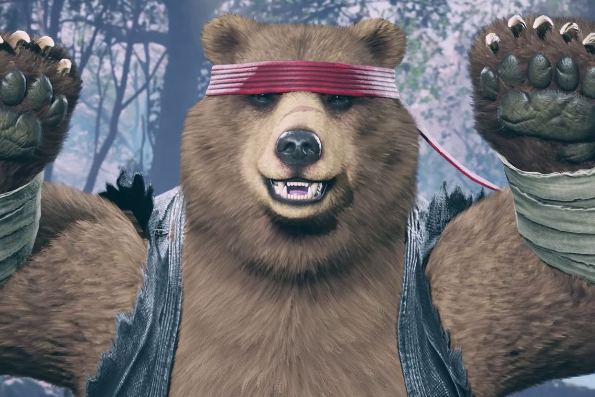 A brown bear wearing a red headband and a jean jacket with cut-off sleeves poses happily for the camera.