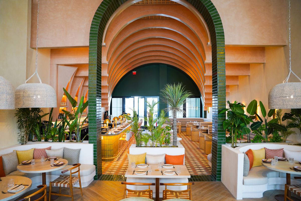 Interior of Planta Cocina, with archways and vibrant tiles and pillows.