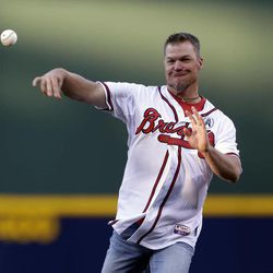 Former Atlanta Braves third baseman Chipper Jones throws out the first pitch for an opening day baseball game between the Braves and the Philadelphia Phillies, Monday, April 1, 2013, in Atlanta. 