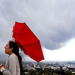 Kara Smith of Brooklyn, New York, almost loses her umbrella as a gust of wind pops it open at Ensign Peak in Salt Lake City on Wednesday, Oct. 5, 2016. Smith and her husband, Taylor, walked to the peak to get a view of the city and the mountains. The newlyweds have taken new jobs and are moving to Salt Lake City in a month.