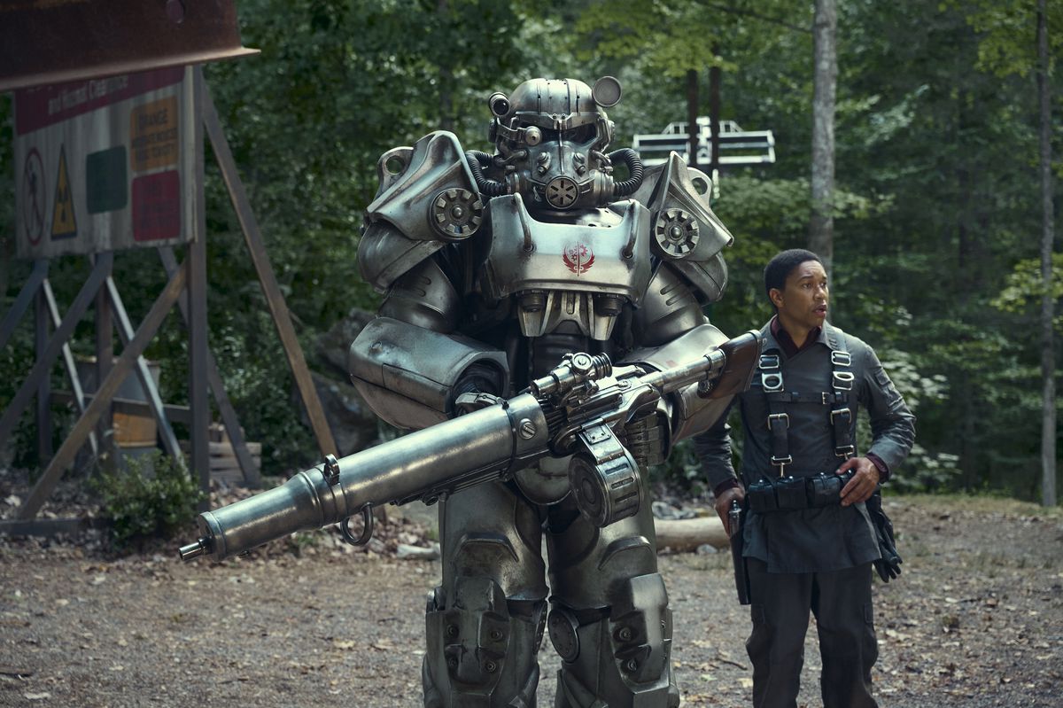 A person in power armor stands next to a regular person in an image from Amazon Prime Video’s Fallout series