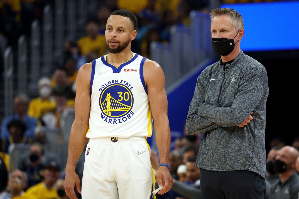 Steph Curry and Steve Kerr standing on the sideline