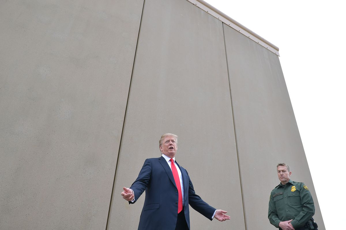 President Donald Trump speaks in front of a border wall prototype.