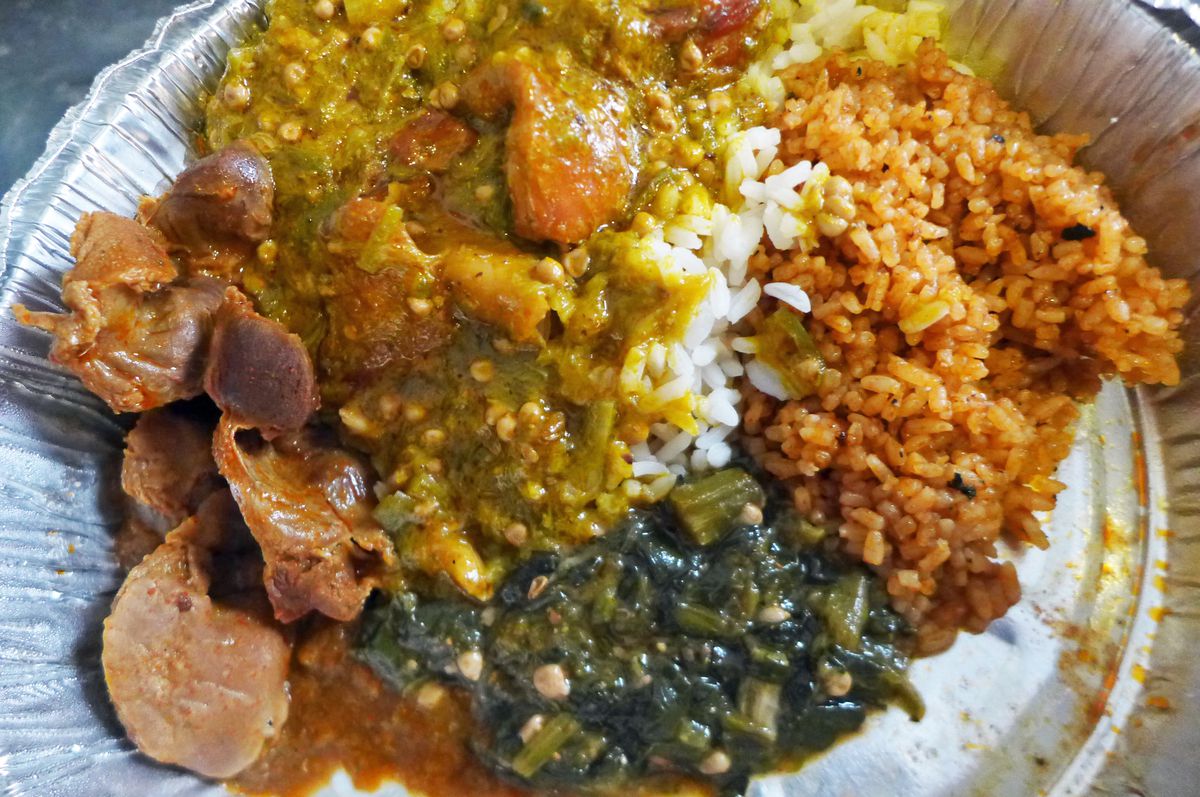 Typical West African meal of okra stew, chicken gizzards, and Joloff rice