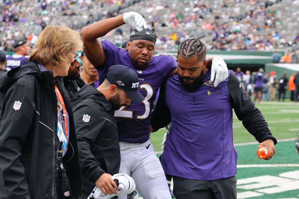 Kyle Fuller #23 of the Baltimore Ravens is helped off the field after suffering an injury during the second half against the New York Jets at MetLife Stadium on September 11, 2022 in East Rutherford, New Jersey.