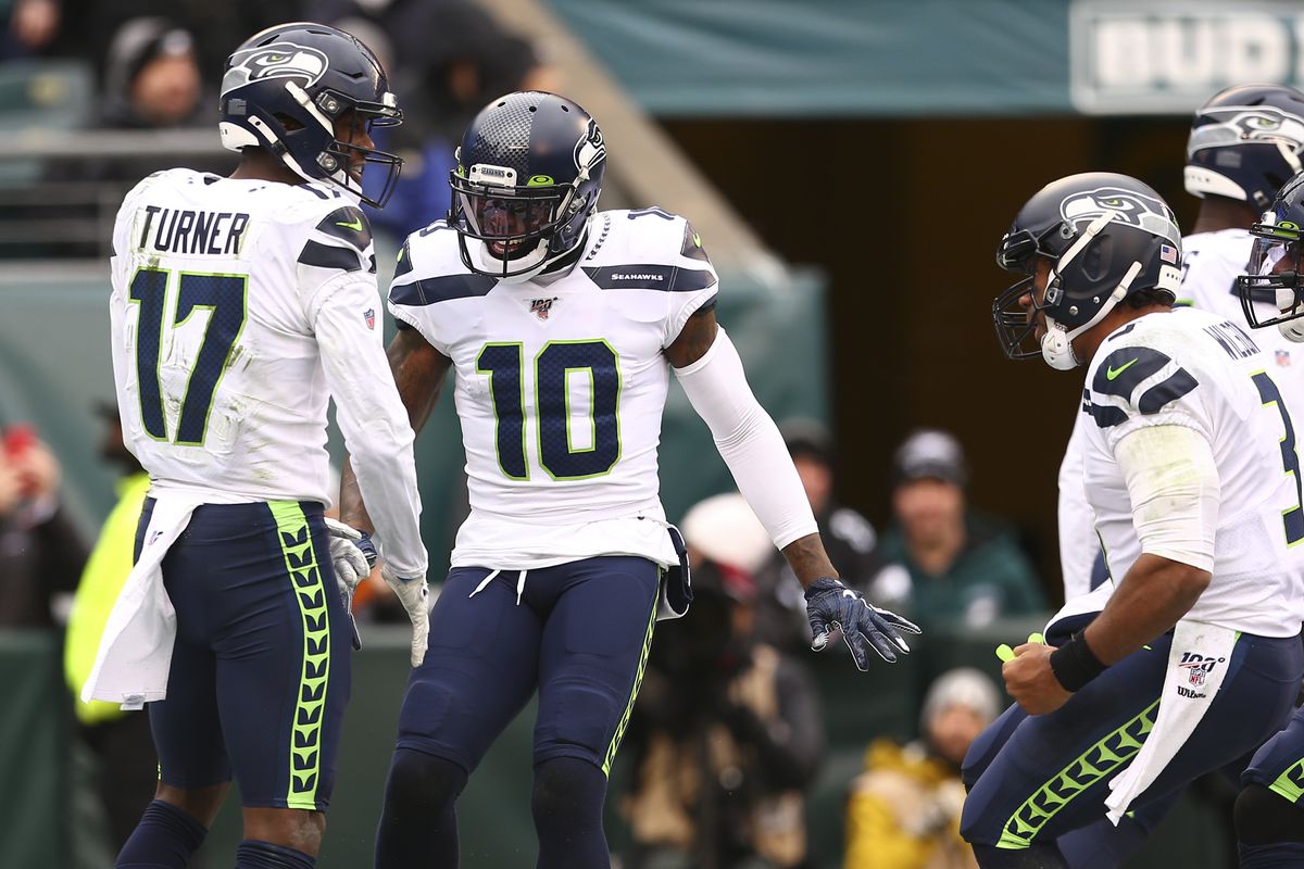 Malik Turner of the Seattle Seahawks celebrates his touchdown catch with Josh Gordon and Russell Wilson against the Philadelphia Eagles in the first half at Lincoln Financial Field on November 24, 2019 in Philadelphia, Pennsylvania.