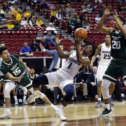 Utah State Aggies guard Koby McEwen tries to shoot with Colorado State Rams guard Anthony Bonner and forward Deion James defending during the Mountain West Conference basketball tournament in Las Vegas on Wednesday, March 7, 2018.