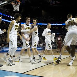 Iowa's Adam Woodbury, third from left, celebrates with teammates after scoring the game-winning basket in their 72-70 win over against Temple in overtime. (AP Photo/Mary Altaffer)