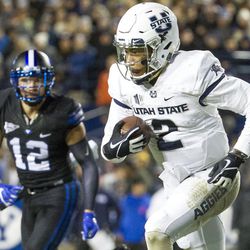Utah State quarterback Kent Myers (2) runs with the ball during an NCAA college football game against Brigham Young in Provo on Saturday, Nov. 26, 2016.