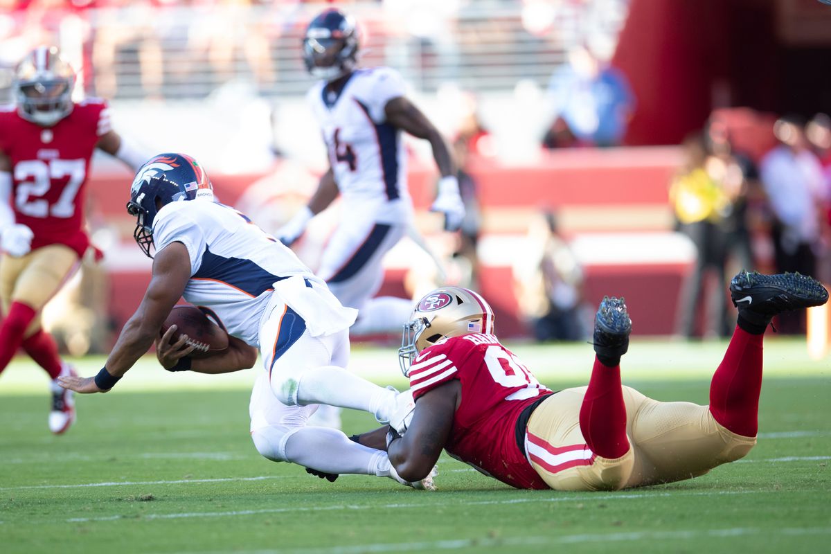 Javon Hargrave #98 of the San Francisco 49ers tackles Russell Wilson #3 of of the Denver Broncos during the game at Levi’s Stadium on August 19, 2023 in Santa Clara, California. The 49ers defeated the Broncos 21-20.